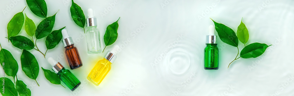 Cosmetics in a bottle in water, skin hydration concept. Selective focus. Cosmetics in a bottle in water, skin hydration concept. Selective focus.