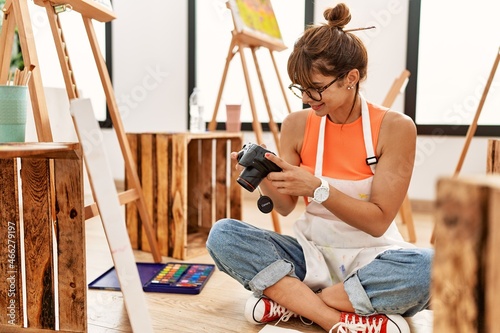 Young hispanic woman make picture to draw at art studio photo