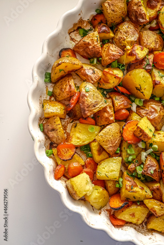 Roasted potatoes in the oven with spices and herbs close-up, food background life style, homemade potatoes recipe authentic, vegan cuisine