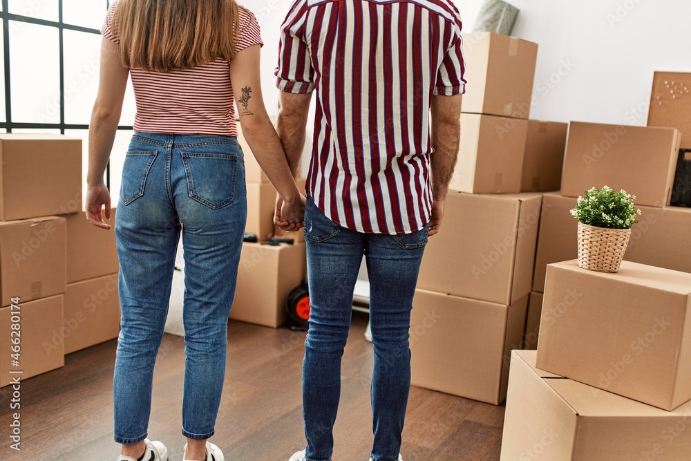 Couple on back view holding hands at new home. Couple on back view holding hands at new home.