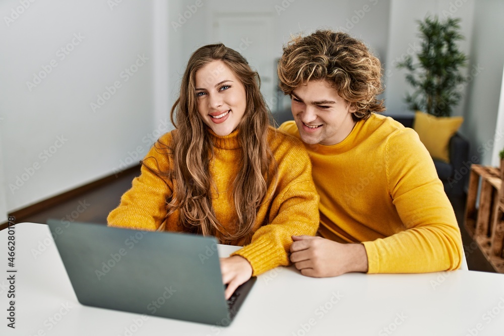 Young caucasian couple smiling confident using laptop at home Young caucasian couple smiling confident using laptop at home