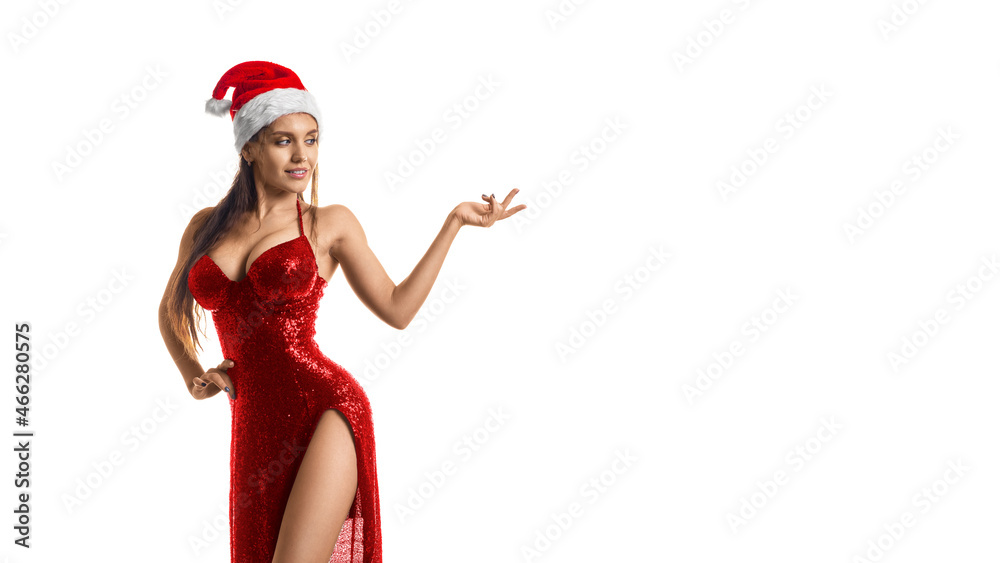 Stylish brunette woman in red dress and Santa hat showing on your product isolated on white background. Format photo 16x9.