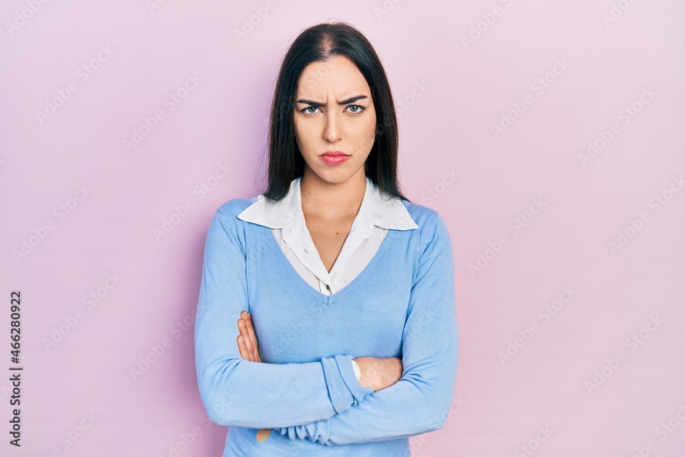 Beautiful woman with blue eyes standing over pink background skeptic and nervous, disapproving expression on face with crossed arms. negative person. Beautiful woman with blue eyes standing over pink background skeptic and nervous, disapproving expression on face with crossed arms. negative person.