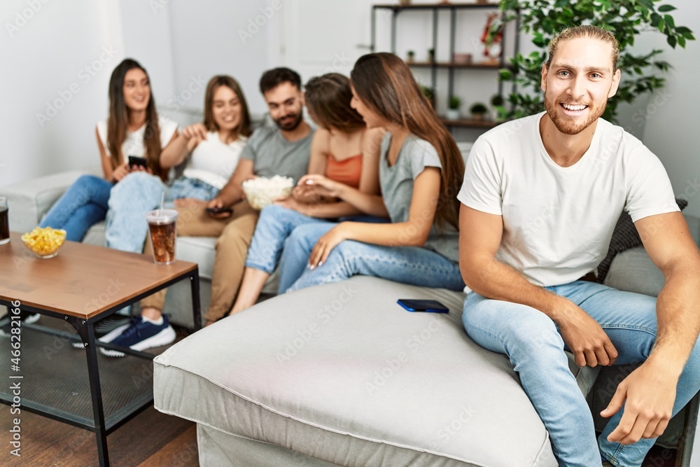 Group of young friends smiling happy watching movie at home. Group of young friends smiling happy watching movie at home.