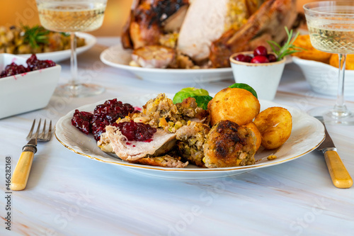 Traditional Christmas dinner with roasted turkey, apricot and pistachio stuffing, roast potatoes and cranberry sauce