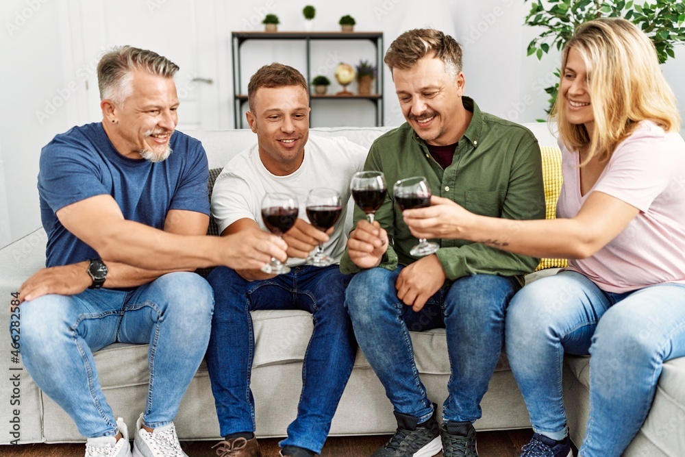 Group of middle age friends toasting with glass of wine at home. Group of middle age friends toasting with glass of wine at home.