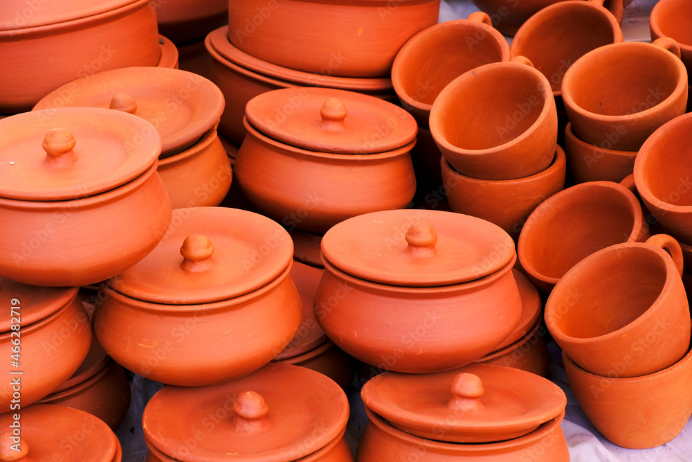 Terracotta, pot, cup kitchen souvenirs pile at street handicraft pottery shop. handmade terracotta Products in handicraft market in Pune, India. Terracotta, pot, cup kitchen souvenirs pile at street handicraft pottery shop. handmade terracotta Products in handicraft market in Pune, India.