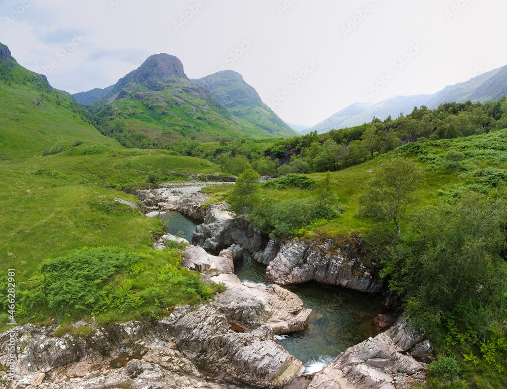 Aerial panoramic view of the waterfalls on the River Coe near Allt-na-ruigh with the Three Sisters in the background, Scotland Aerial panoramic view of the waterfalls on the River Coe near Allt-na-ruigh with the Three Sisters in the background, Scotland