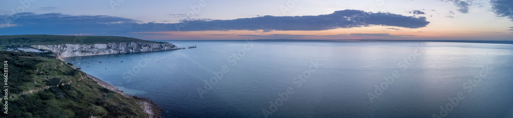 Heather and autumn evening light on Headon Warren with the Needles peninsular and lighthouse, Isle of Wight, UK
