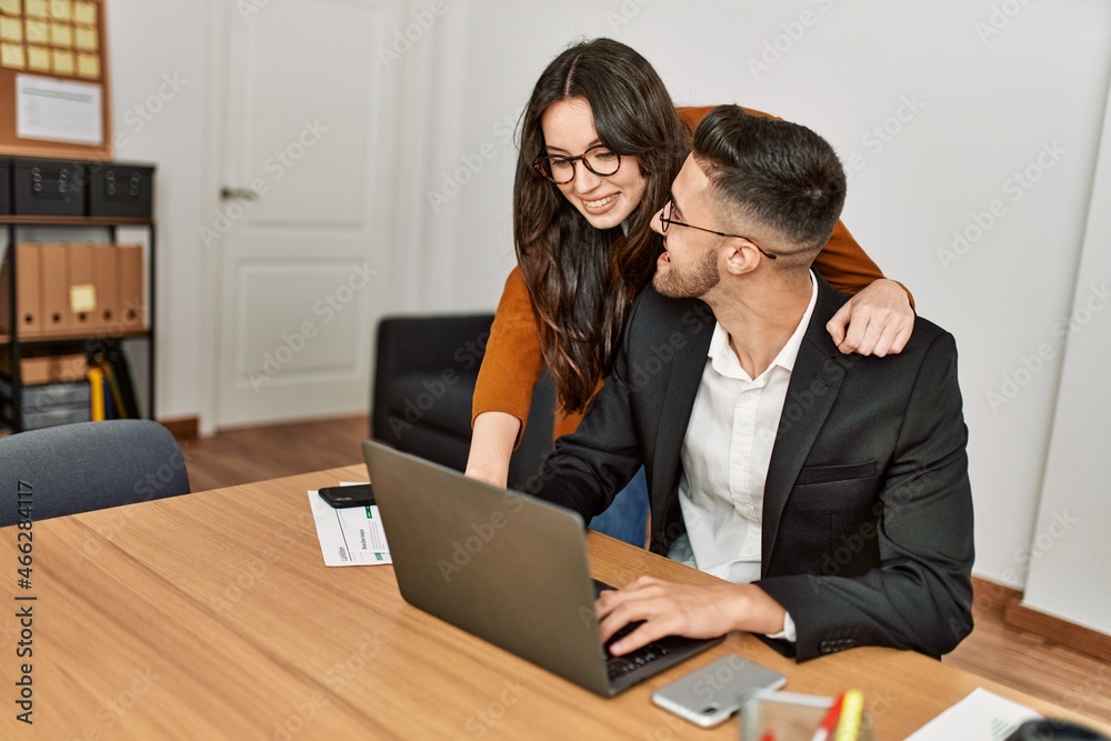 Two hispanic business workers smiling happy working at the office. Two hispanic business workers smiling happy working at the office.