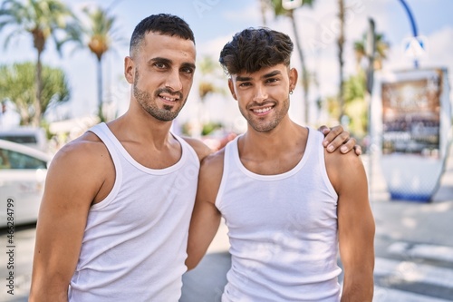 Young hispanic couple smiling happy hugging at the city.