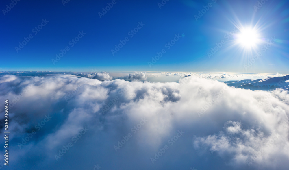 Naklejka premium Flight through evening sky with clouds over mountain