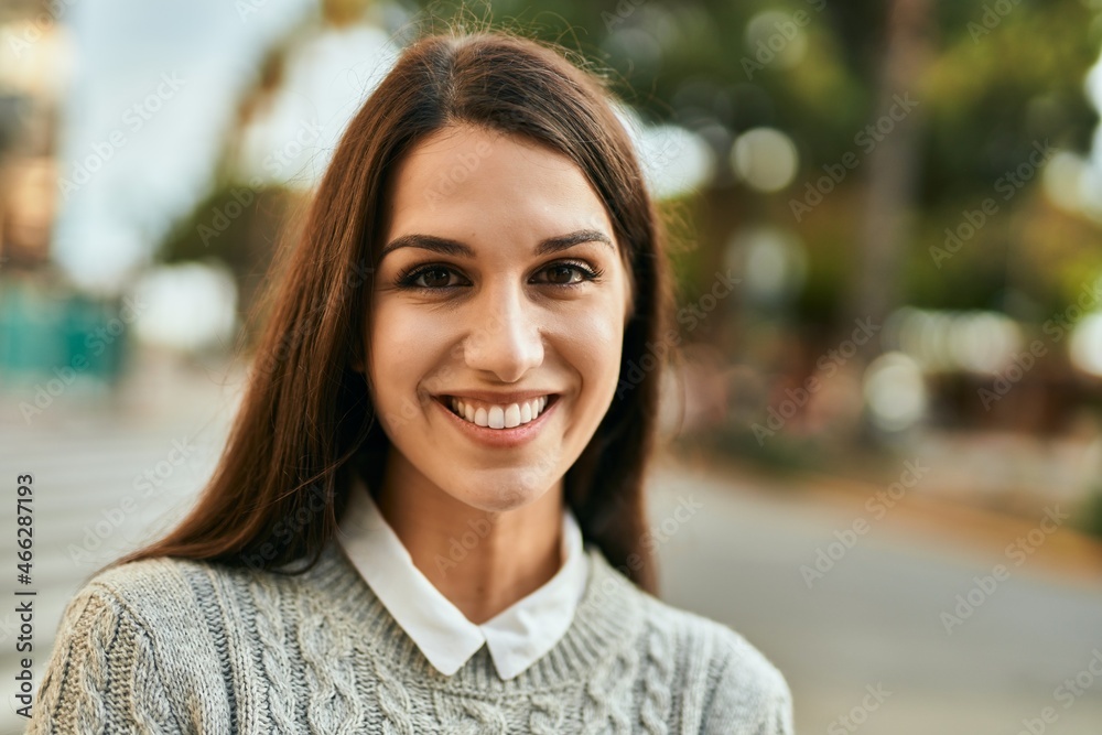 Fototapeta premium Young hispanic woman smiling happy standing at the city.