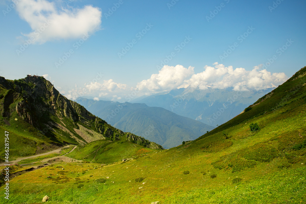 mountain climbing scene, meadow landscape in summer on the top of the alps,panoramic view of the peaks and green grass