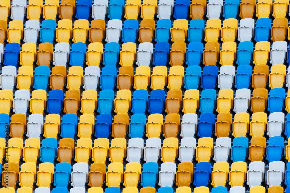 Fototapeta premium Closeup of yellow and blue seats on stadium