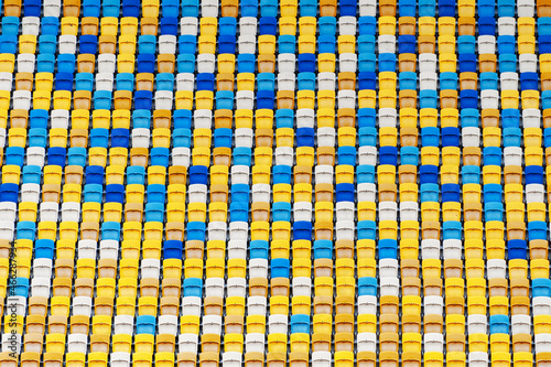 Closeup of yellow and blue seats on stadium