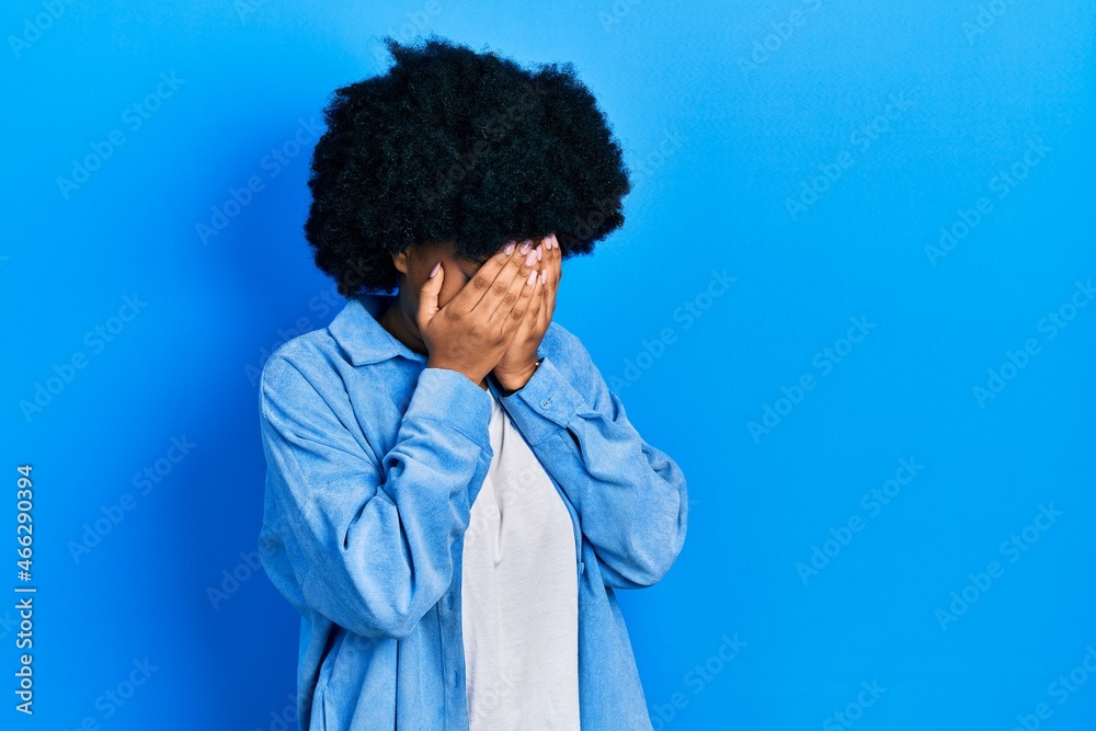 Young african american woman wearing casual clothes with sad expression covering face with hands while crying. depression concept.
