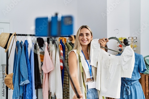 Young blonde woman smiling confident make selfie by the smartphone at clothing store