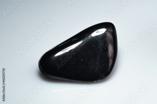 natural black shungite cabochon on the background photo