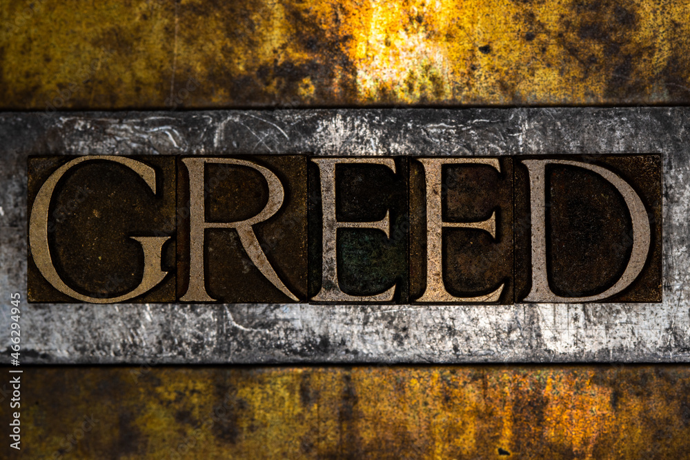 Greed text message on textured grunge copper and vintage gold background