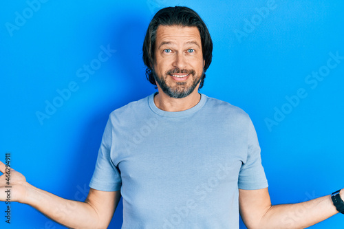 Middle age caucasian man wearing casual clothes smiling showing both hands open palms, presenting and advertising comparison and balance © Krakenimages.com