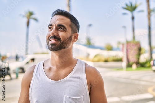 Hispanic sports man wearing workout style outdoors on a sunny day © Krakenimages.com