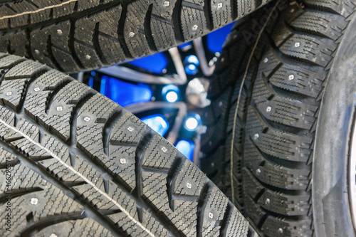 studded winter tires, Set of winter studded rubber on blue background, selective focus
