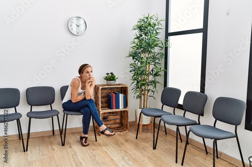 Young caucasian woman desperate sitting on chair at waiting room