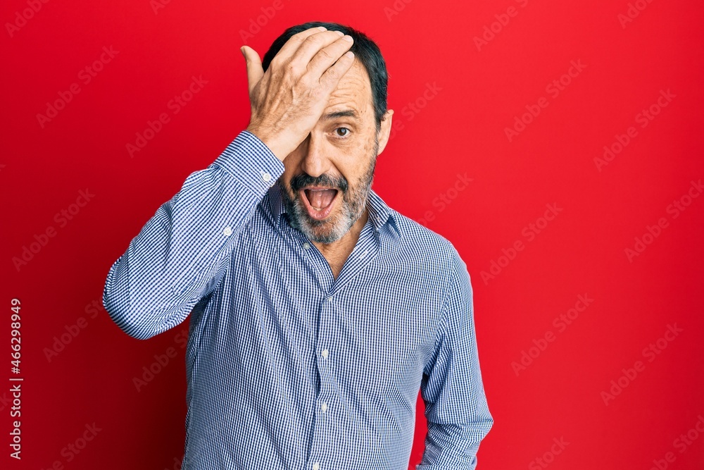 Middle age hispanic man wearing casual clothes surprised with hand on head for mistake, remember error. forgot, bad memory concept. Middle age hispanic man wearing casual clothes surprised with hand on head for mistake, remember error. forgot, bad memory concept.