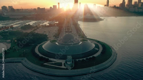 Aerial: Adler Planetarium On Lake Michigan with light rays shining through buildings, Chicago, Usa