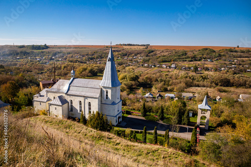 Catholic church in the valley of the village Zinkiv on an autumn day. Ukraine.