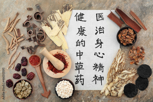 Fotografie Ancient Chinese herbal medicine with herbs, spice and calligraphy script on rice paper