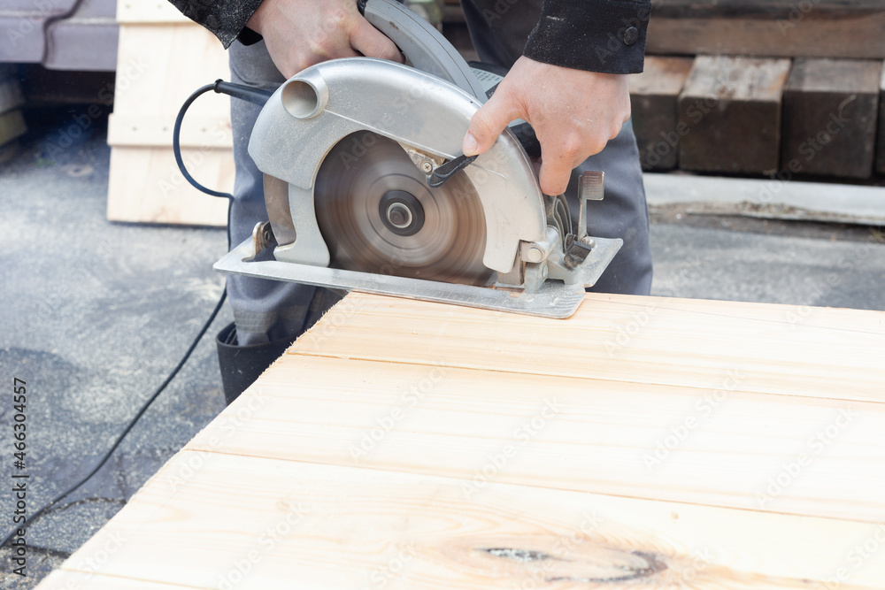 light wooden boards are sawn with an electric saw light wooden boards are sawn with an electric saw