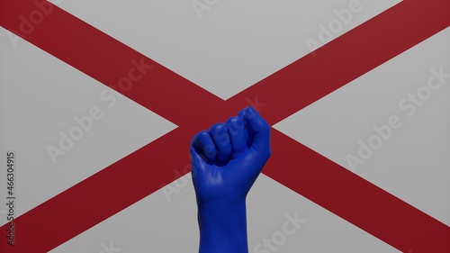 Fotografie A single raised blue fist in the center in front of the US state flag of Alabama