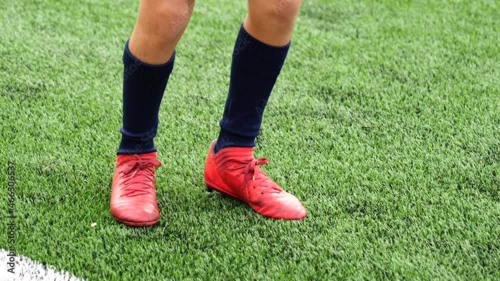 Teenager boy warming up his feet on soccer field Teenager boy warming up his feet on soccer field