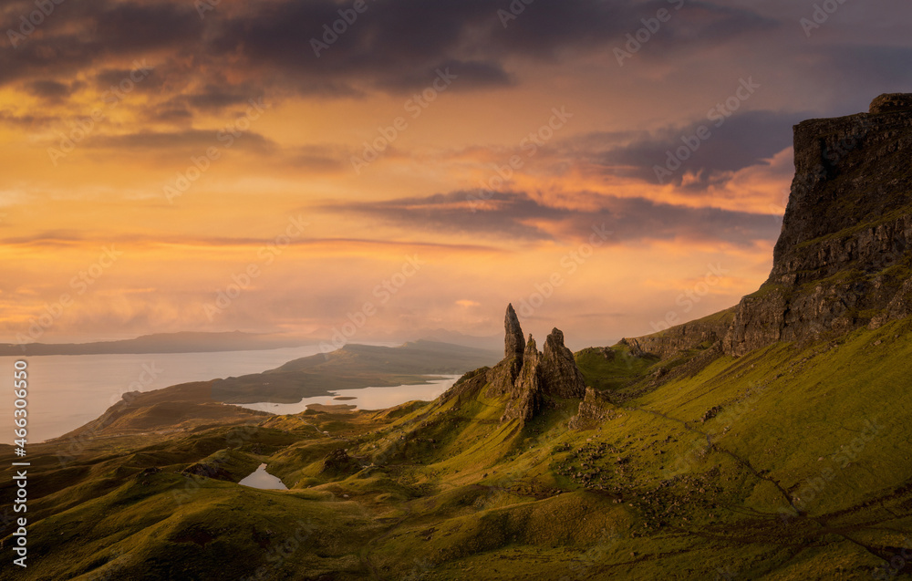 Scottish Highlands and Isle of Skye. Sunrise at the Old Man of Storr on the Isle of Skye, Scotland United Kingdom. Background photo of stunning landscape at sunrise with orange sky