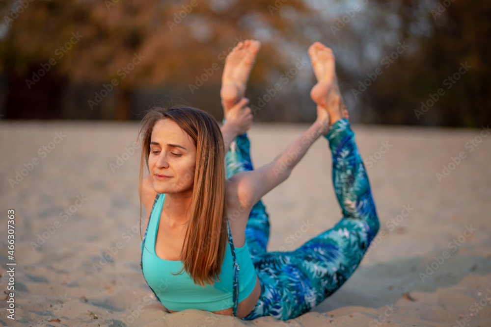 postures yoga. yogi girlon the beach, balance, fitness, stretching and relaxation	
