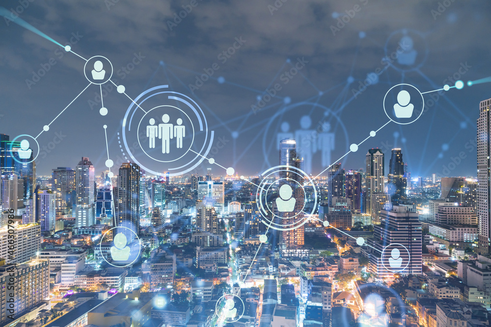 Glowing social media icons on night panoramic city view of Bangkok, Southeast Asia. The concept of networking and establishing new connections between people in businesses. Double exposure. Glowing social media icons on night panoramic city view of Bangkok, Southeast Asia. The concept of networking and establishing new connections between people in businesses. Double exposure.