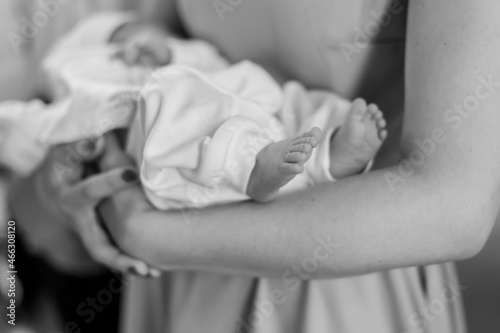 little baby feet baby on mother's arm