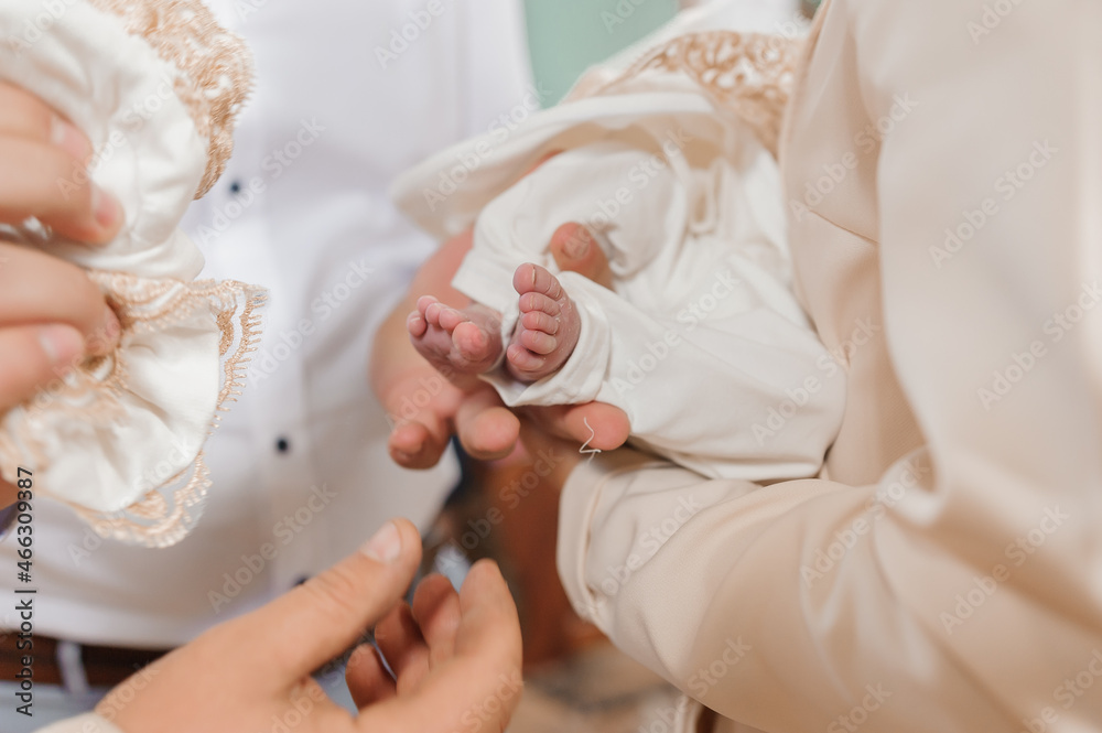 Obraz premium sacrament of baptism the priest baptizes the child with the anointing