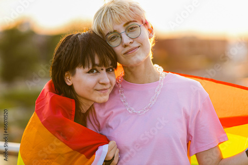 Portrait of a gender fluid couple wearing rainbow flag
