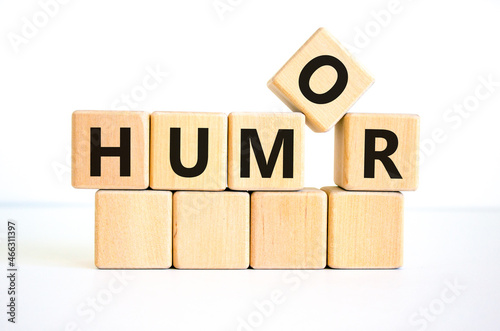 Humor symbol. The concept word 'humor' on wooden cubes. Beautiful white table, white background, copy space. Business, psychological and humor concept. photo