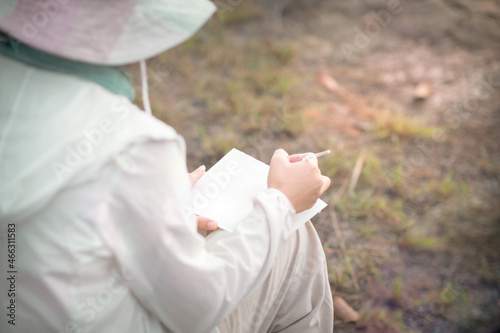 girl sitting painting on a sunny day
