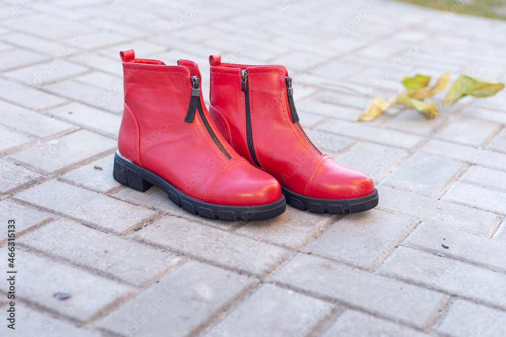 a pair of women's red shoes stand on the tiles in the fall a pair of women's red shoes stand on the tiles in the fall