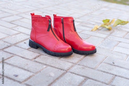 a pair of women's red shoes stand on the tiles in the fall
