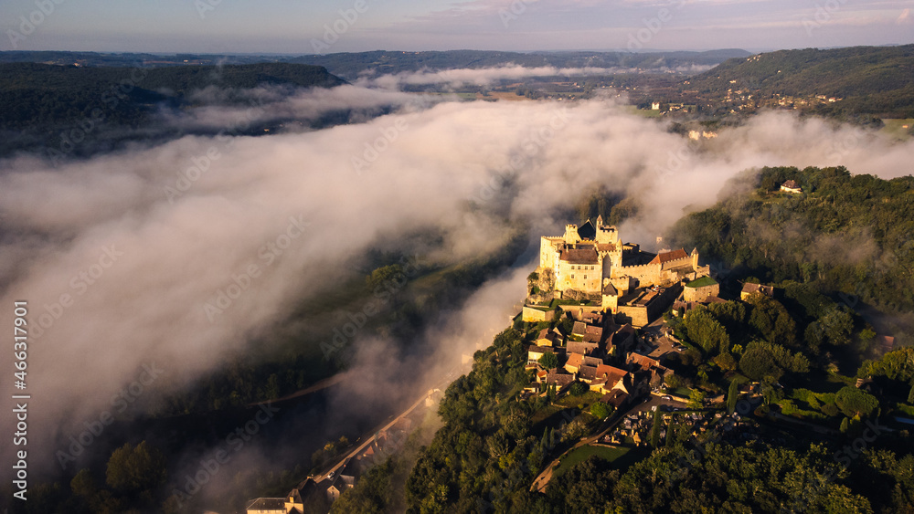 Aerial medieval castle Sunset dramatic view of Beynac-et-Cazenac in France near the dordogne river