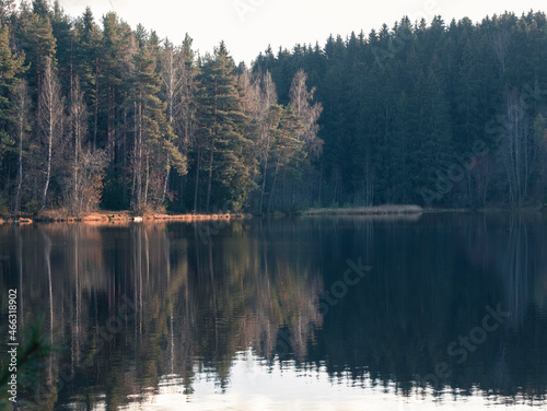 Autumn forest, trees and hills are reflected in the lake. Park in Toksovo Leningrad region Russia © Lana Kray