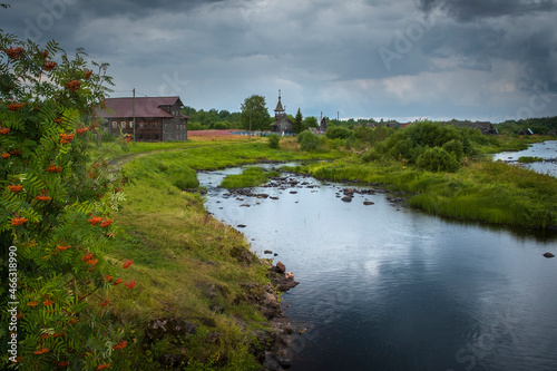 The historic village of Pyalma in the Republic of Karelia on the river bank during summer rain