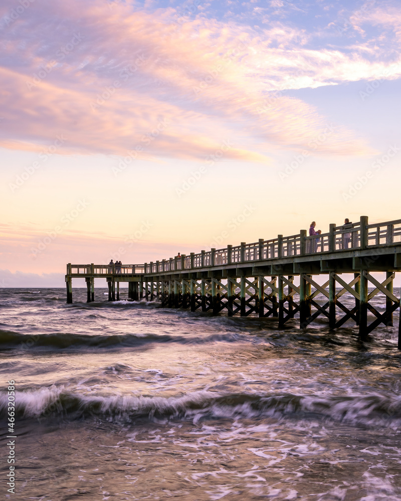 Milford, CT - USA -Oct. 16, 2021: Vertical sunset view of the Albert Munroe Pier at Walnut Beach, during the evening golden hour.