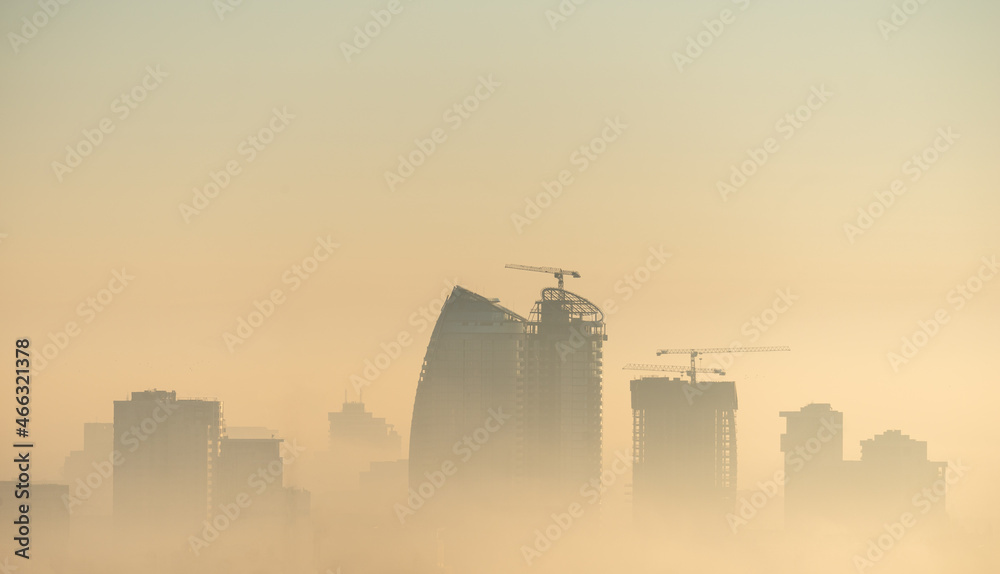 City skyline at sunrise, foggy morning